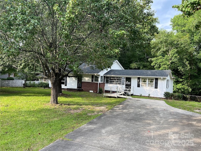 ranch-style house with a front lawn and brick siding