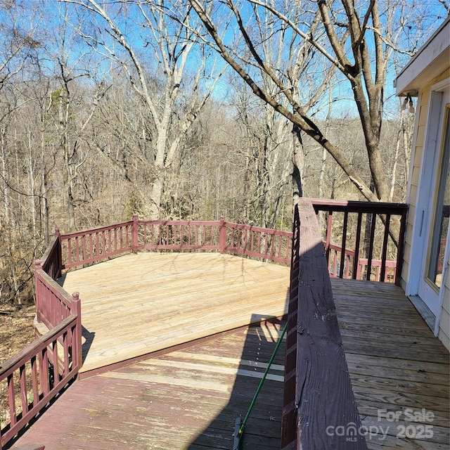 wooden terrace with a view of trees