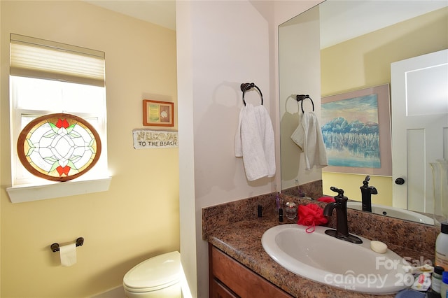 bathroom featuring toilet and vanity