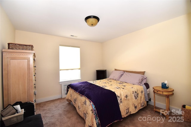 carpeted bedroom featuring visible vents and baseboards