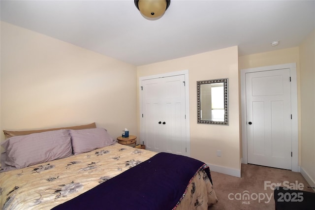 bedroom featuring carpet, a closet, and baseboards