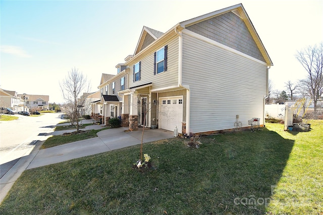 view of side of property featuring a garage, a residential view, concrete driveway, and a yard