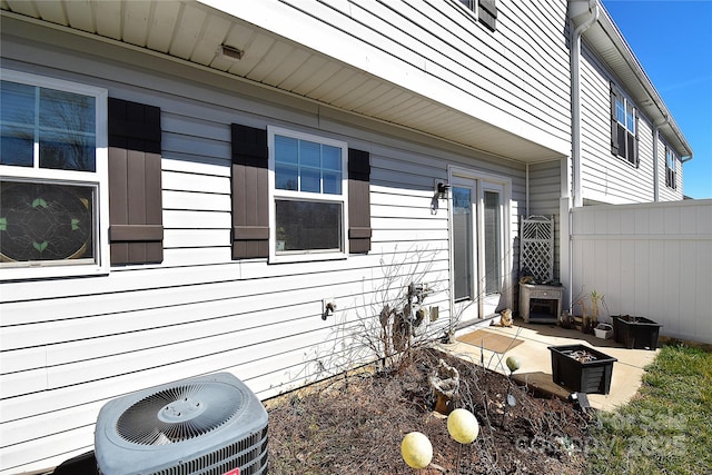 view of home's exterior featuring a patio area, fence, and central air condition unit