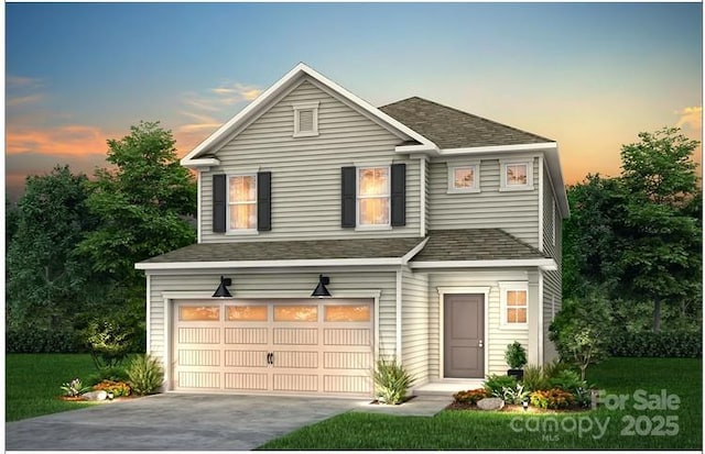 traditional home featuring a garage, concrete driveway, and roof with shingles