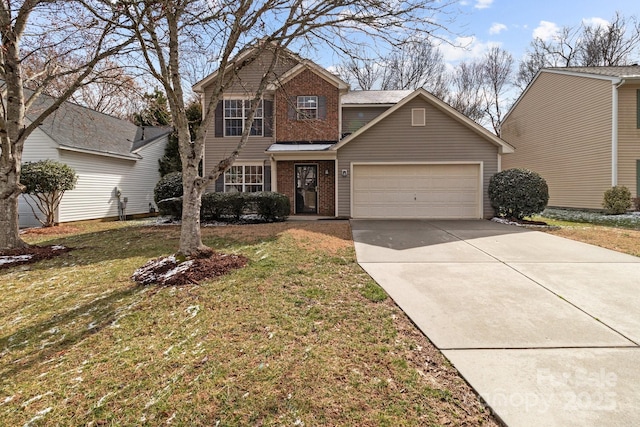 traditional home with an attached garage, driveway, a front yard, and brick siding