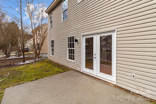 exterior space featuring a patio, french doors, and a lawn