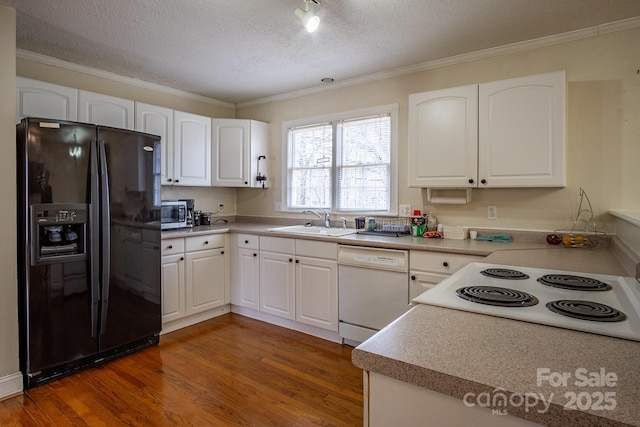 kitchen with white appliances, dark wood-style flooring, a sink, and white cabinets