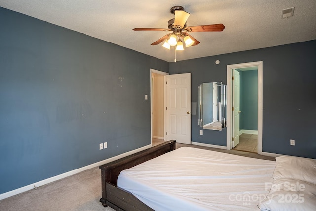 bedroom with a textured ceiling, carpet, visible vents, and baseboards