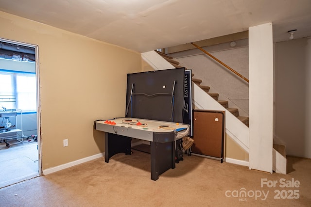 playroom featuring light colored carpet and baseboards