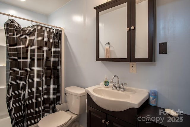 bathroom with toilet, vanity, and a shower with curtain