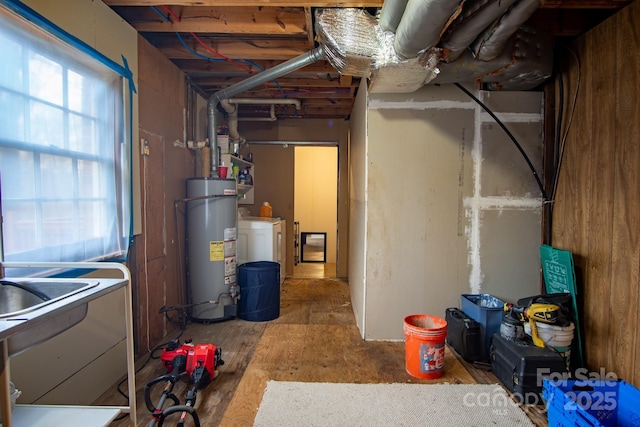 below grade area featuring secured water heater and washer / dryer