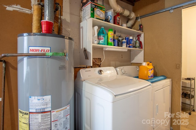 washroom featuring laundry area, water heater, and independent washer and dryer