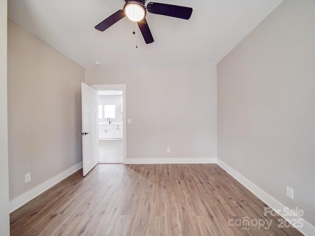 unfurnished bedroom with wood finished floors, a ceiling fan, and baseboards