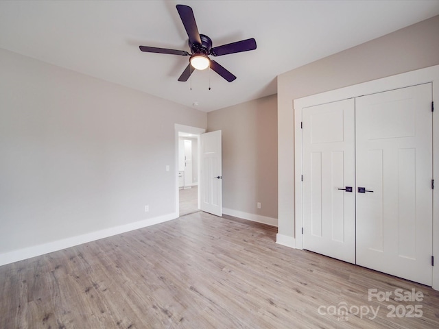 unfurnished bedroom featuring a closet, baseboards, ceiling fan, and light wood finished floors