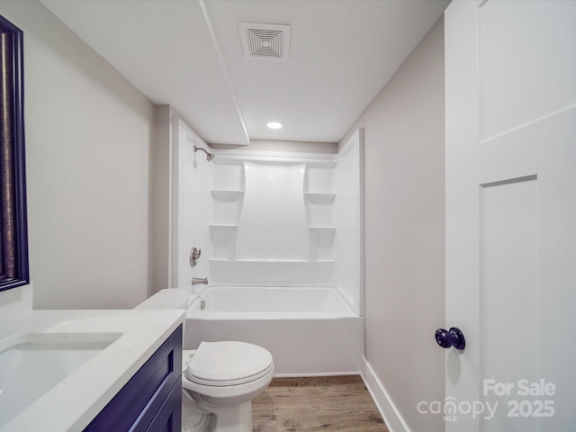 bathroom featuring toilet, wood finished floors, vanity, bathing tub / shower combination, and visible vents