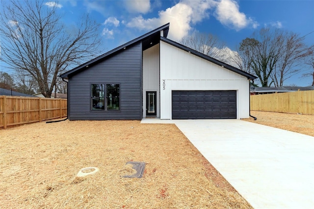 exterior space featuring a garage and fence