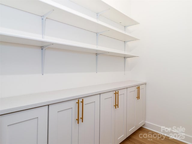 interior details featuring baseboards and wood finished floors