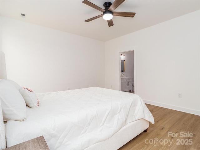 bedroom with light wood finished floors, visible vents, ensuite bathroom, ceiling fan, and baseboards