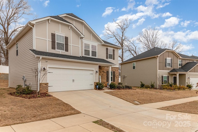 view of front of property featuring a garage, a shingled roof, and concrete driveway