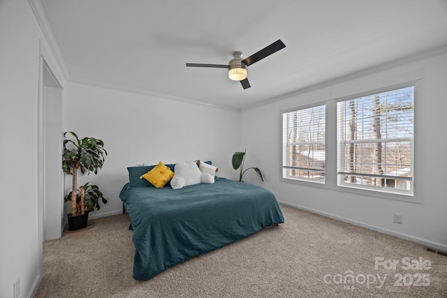 bedroom with baseboards, carpet flooring, visible vents, and crown molding