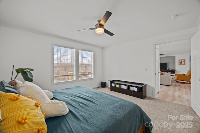 bedroom with ornamental molding, carpet floors, baseboards, and a ceiling fan