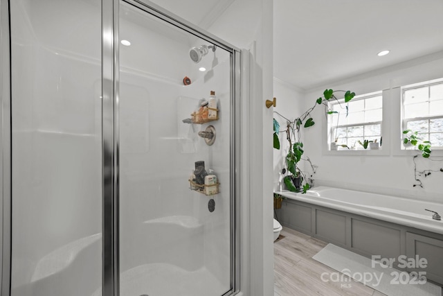 full bath featuring a stall shower, wood finished floors, crown molding, and a bath