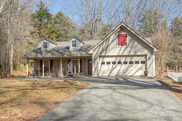 view of front of property with a porch, a shingled roof, a front yard, a garage, and driveway