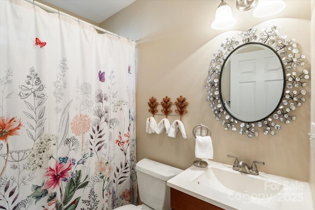 bathroom featuring toilet and vanity