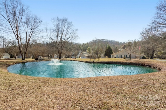 view of pool featuring a lawn