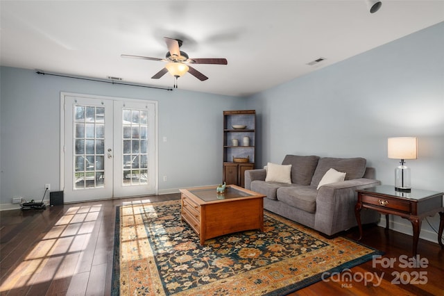 living room with french doors, visible vents, a ceiling fan, wood finished floors, and baseboards