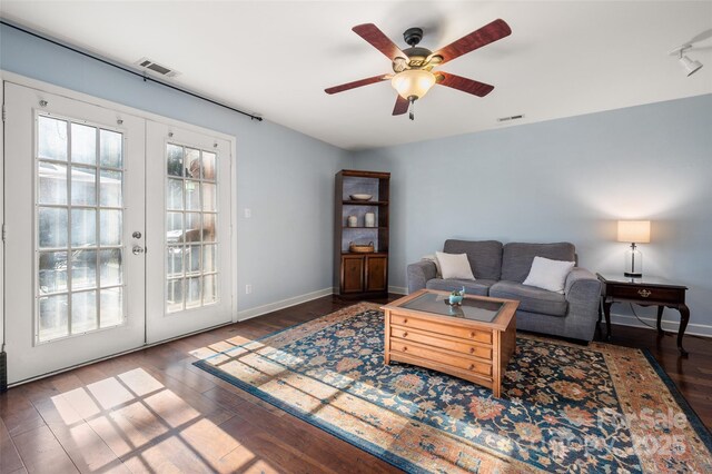 living room featuring french doors, wood finished floors, visible vents, and baseboards