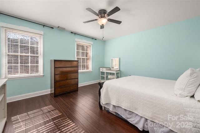 bedroom with visible vents, baseboards, ceiling fan, and wood finished floors