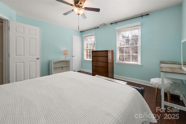 bedroom with a ceiling fan, baseboards, and wood finished floors