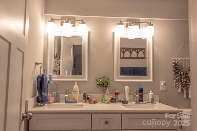 full bathroom featuring a sink and double vanity