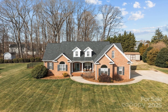 view of front facade with brick siding, a front lawn, roof with shingles, crawl space, and driveway