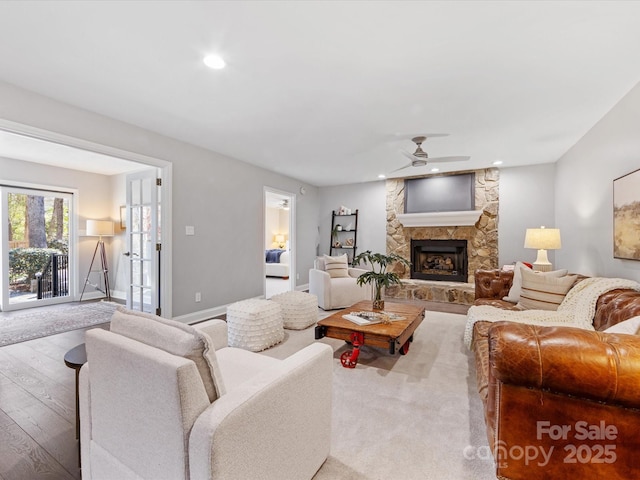 living area featuring a fireplace, recessed lighting, ceiling fan, wood finished floors, and baseboards