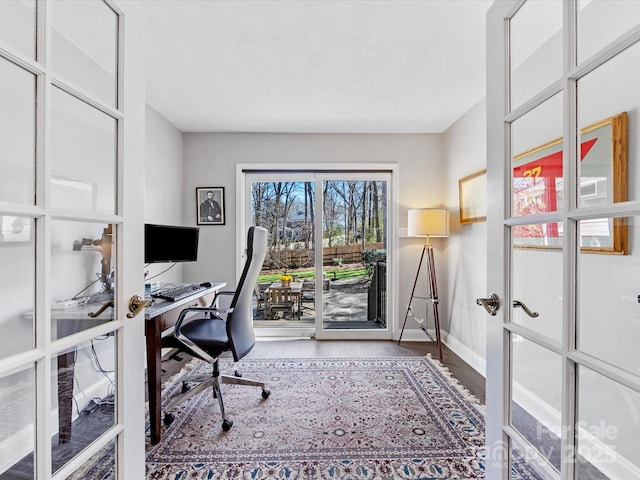 office featuring french doors, wood finished floors, and baseboards