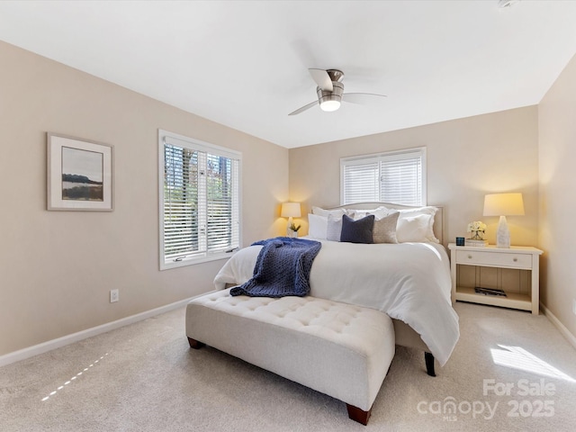 bedroom featuring light carpet, baseboards, and a ceiling fan