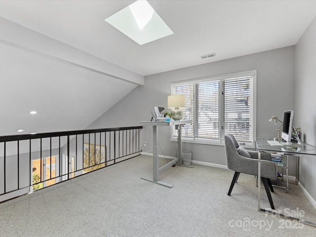 office space featuring a skylight, visible vents, baseboards, carpet, and beam ceiling