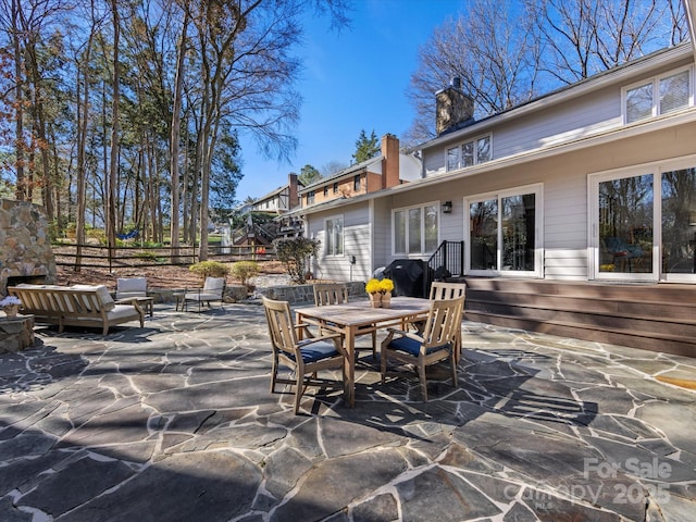 view of patio featuring fence and outdoor dining space