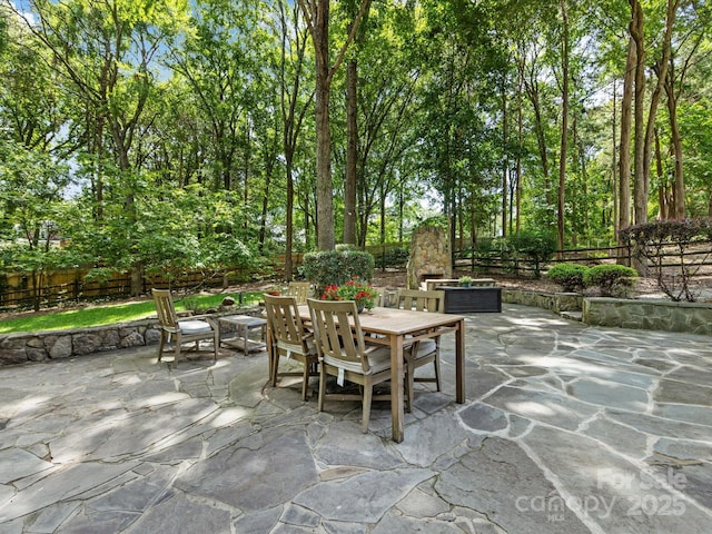 view of patio / terrace featuring a fire pit, fence, and outdoor dining space