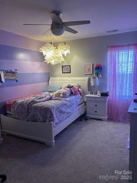 carpeted bedroom featuring visible vents and ceiling fan