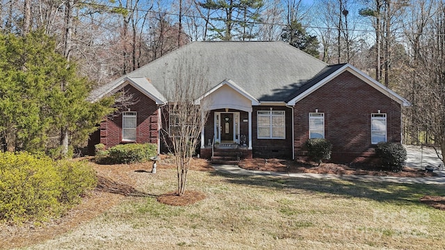 ranch-style house with brick siding, crawl space, a front yard, and a shingled roof