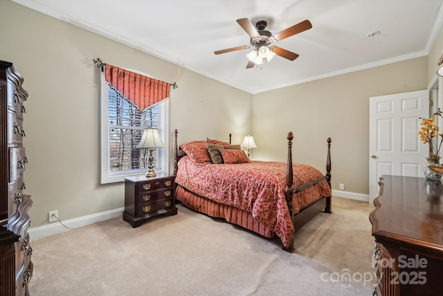 carpeted bedroom featuring ornamental molding, ceiling fan, and baseboards