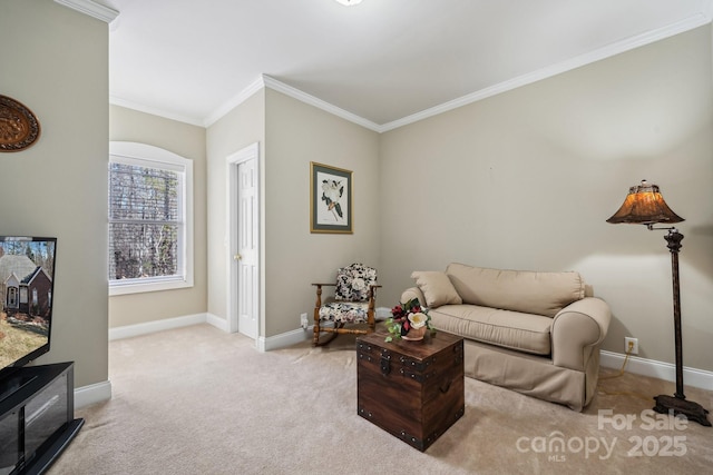 sitting room featuring light carpet, ornamental molding, and baseboards