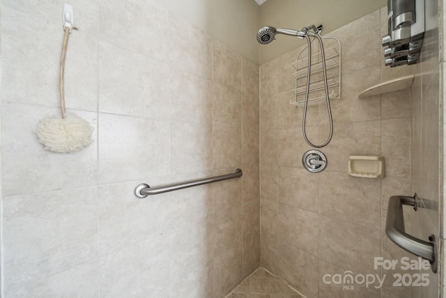 bathroom with tiled shower