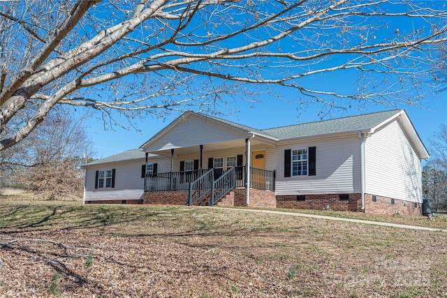 single story home featuring covered porch, roof with shingles, a front lawn, and crawl space