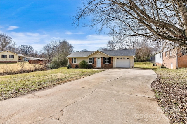 ranch-style home with a garage, brick siding, driveway, and a front lawn