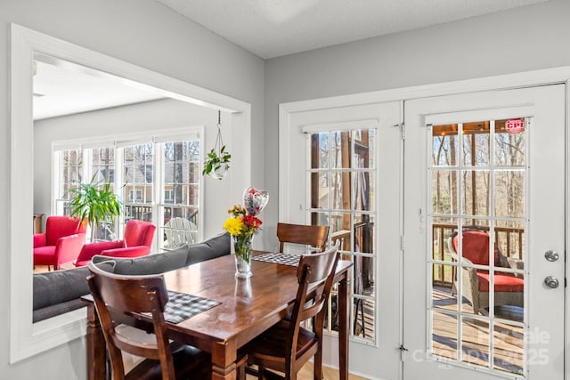 dining room featuring a textured ceiling and french doors