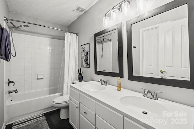 full bathroom featuring a textured ceiling, shower / bath combo with shower curtain, a sink, and visible vents